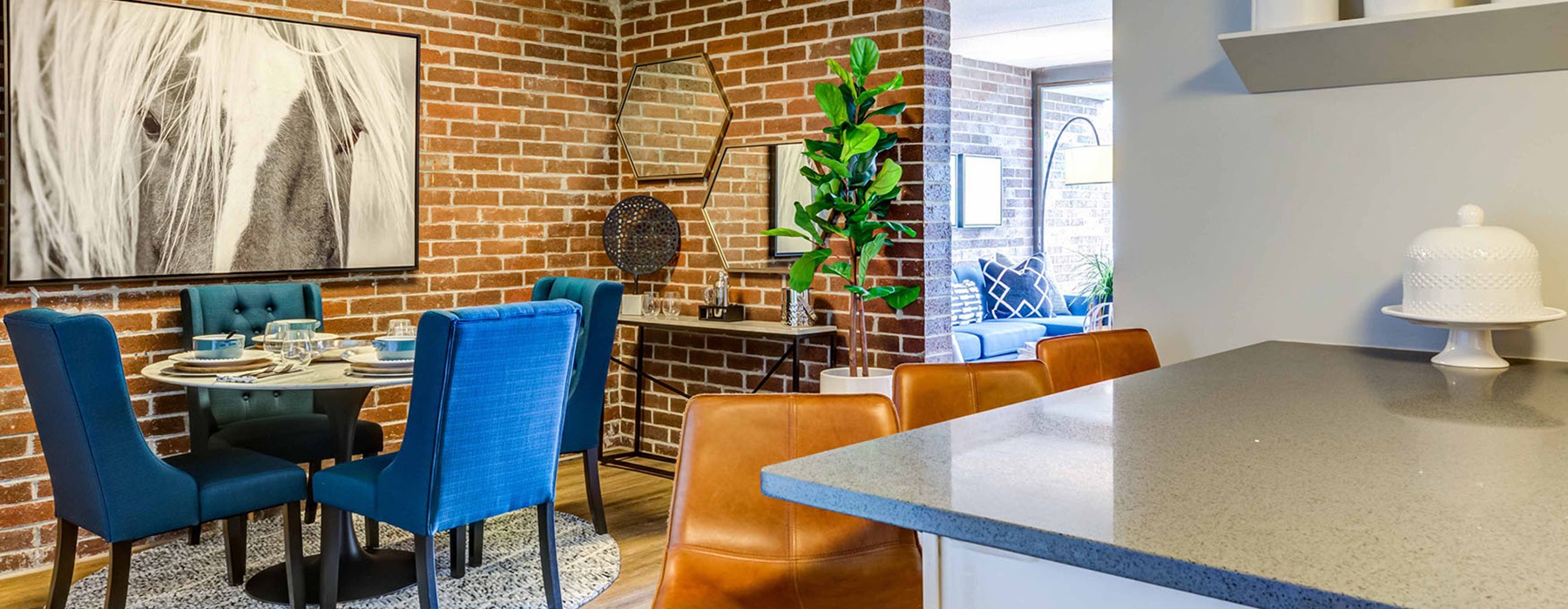dining area with brick walls and easily connected kitchen area