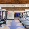 fitness center with rows of treadmills and modern style flooring