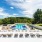 the green at 9&90 apartments in framingham pool with reclining seats and lush landscaping