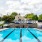 pool with reclining seats and lush landscaping and tiers