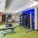fitness center rendering showing plenty of equipment and modern decor in a large, spacious room