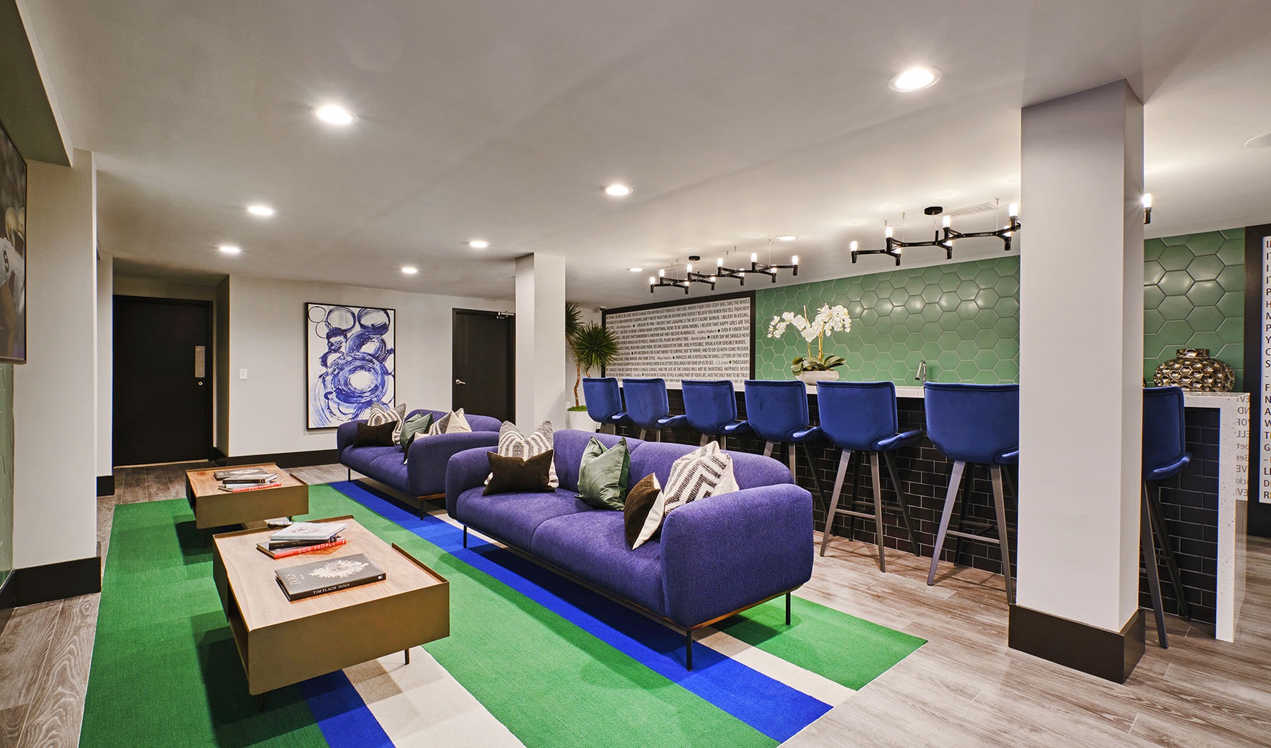 The Green at 9 and 90 Main Homepage image showing our amenity space with couches bar and tv